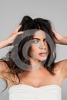 dissatisfied woman touching tousled hair and