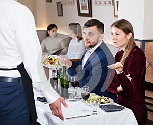 Dissatisfied young couple expressing dissatisfaction with food