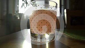 Dissolving Aspirin fizzy pill in glass of water