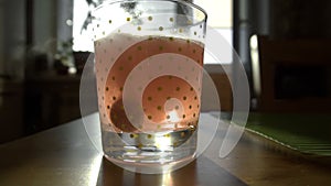 Dissolving Aspirin fizzy pill in glass of water