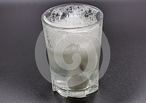 Dissolving instant effervescent tablets in a glass of water closeup