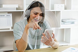 Distance education concept, Teen boy in headphone to listen music and use phone after study online