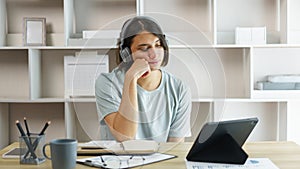 Distance education concept, Teen boy sit to contemplate while listening lecture online on tablet