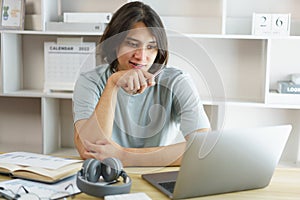 Distance education concept, Teen boy sitting to contemplate while listening lecture online at home