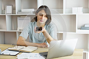 Distance education concept, Teen boy talking on phone and using laptop to lesson class online