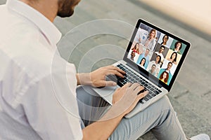 Distance Education. Unrecognizable man having online business training via conference on laptop