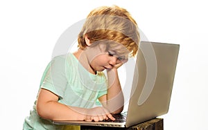 Distance Learning online education. Little boy with laptop. Schoolboy does homework at home.