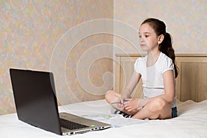 Distance learning online education. Schoolgirl studying at home with digital tablet laptop notebook