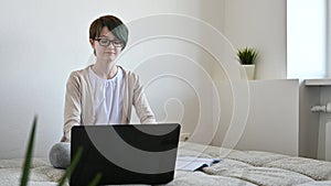 Distance learning online education. Teen schoolgirl studying home using laptop
