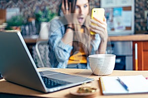 Distance learning online education and work. Business woman having a facetime video call. Surprised girl working from home office