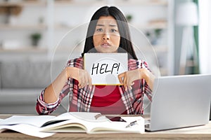 Distance Learning Stress. Frustrated Asian Lady Holding Leaflet With Drawn Help Word