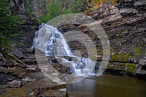 A distance shot of Quality Waterfall near Tumbler Ridge, British Columbia, Canada, long exposure to smooth out the water