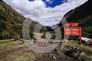 Distance sign to the camps next to a trail in the trekking of the quebrada santa cruz