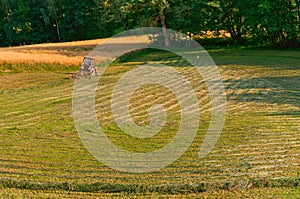 In the distance a tractor working in a field, farmland, agricultural fields