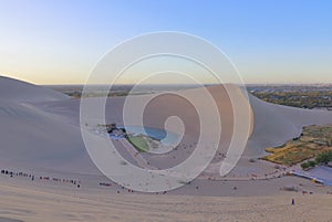 A distance view of Crescent Lake surrounded by Echoing-Sand Mountain Mingsha