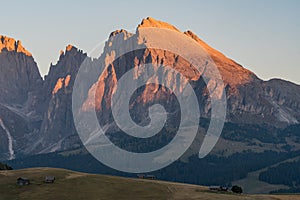 Distance view of the details of the Plattkofel mountain peak during the sunset with red cliffs on Alpe di Siusi, South Tyrol, Ital