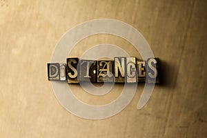 DISTANCES - close-up of grungy vintage typeset word on metal backdrop