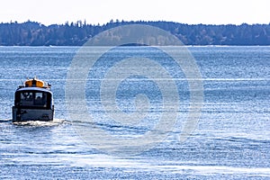 distant boat speeding off towards the horizon