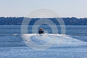 distant boat speeding off towards the horizon