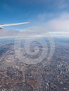 A distant city seen from an aeroplanes window.