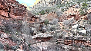 Distant Climber Descends Rocky Trail