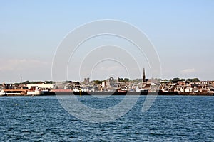 The distant coastline of the old town from afar from the sea side under a clear sky photo