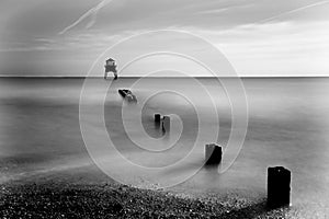 Distant Lighthouse with wall and timbers leading to it