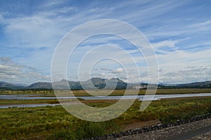 Distant Mountains over still water marshes