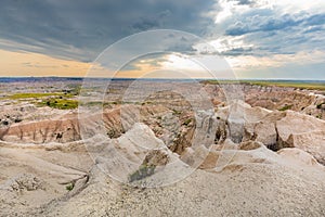 Distant storm clouds move across an alien-looking landscape.