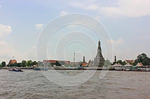 Distant view of Buddhist temple of Wat Arun Ratchawararam or Temple of Dawn in Bangkok