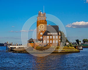 Distant view of a famous clock tower of Venice, Italy, amidst of water with blue sky background.