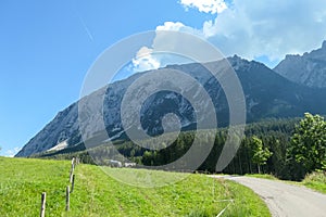 Distant view on Grimming, the highest self standing mountain in Alps, Austria. There is a lush green meadow in front