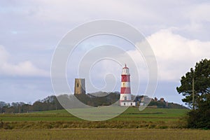 Distant view of Happisburgh lighthouse and church.