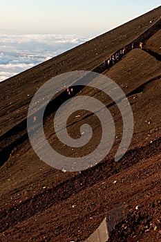 Distant view of hikers on a trail on the slopes of Mt. Fuji, Japan