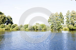 Distant view on the river ems and the beplanted river bank in lathen emsland germany