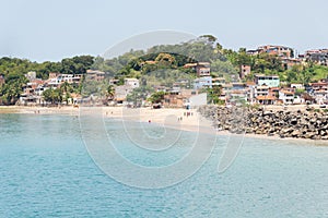 Distant view, from the sea, of the houses on the mountain of the island of Itaparica photo