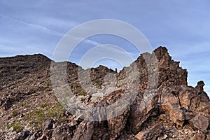 Distant Woman Descending A Desert Mountain Ridge