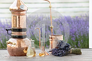 Distillation of lavender essential oil and hydrolate. Copper alambik for the flowering field.