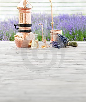 Distillation of lavender essential oil and hydrolate. Copper alambik for the flowering field.