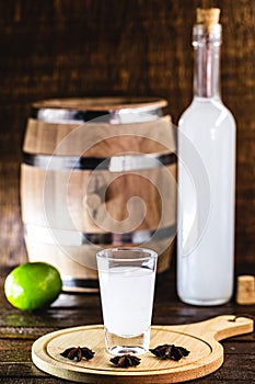 Distilled drink,anise base, on wooden background. Traditional Turkish and Greek appetizer, known as Ouzo, Uzo, Raki, arak or raki