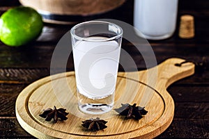 Distilled drink,anise base, on wooden background. Traditional Turkish and Greek appetizer, known as Ouzo, Uzo, Raki, arak or raki