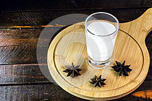 Distilled drink,anise base, on wooden background. Traditional Turkish and Greek appetizer, known as Ouzo, Uzo, Raki, arak or raki