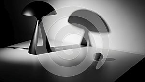 Distinct shadow on a white surface. The lamp features a triangular