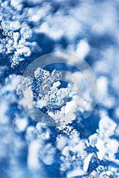 Distinct snowflake on blue velvet detail macro background