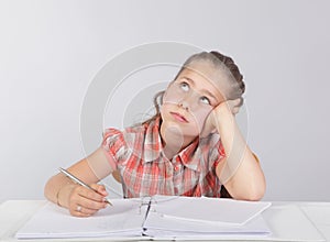 Distracted school kid at homework photo