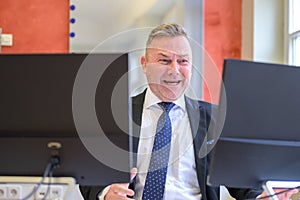 Distraught businessman grimacing at his computer screen