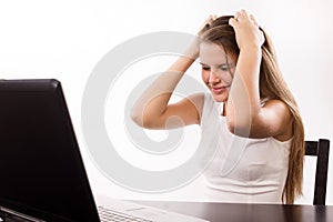 Distraught girl behind a laptop