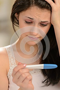 Distraught girl waiting for pregnancy test result