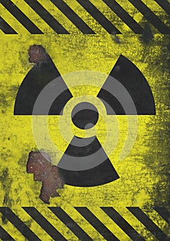 A distressed and corroded rusty metal nuclear radiation warning symbol using yellow and black colors