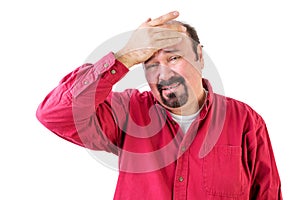 Distressed middle aged man with hand on forehead photo